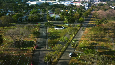 Aerial-view-circling-the-Manila-memorial-park-fountain,-in-sunny-Philippines