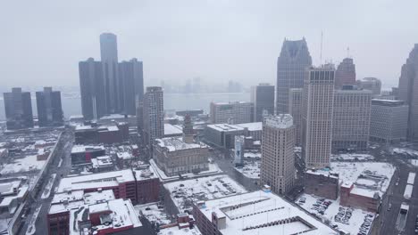 downtown detroit covered in snow during light snowstorm, aerial view