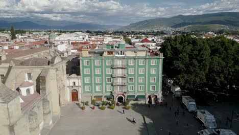 building next to the cathedral of oaxaca, green, in the historic center