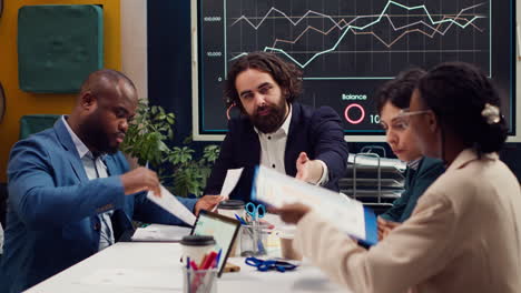business analysts meeting in a boardroom to discuss project stages and updates