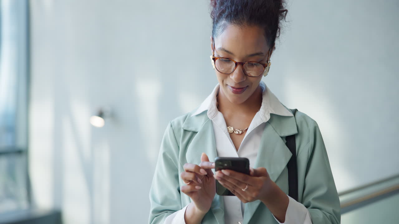 Woman smiles while texting on her phone