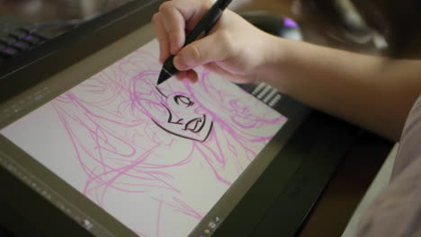 a caucasian woman's hand draws a digital illustration on a tablet in slow motion