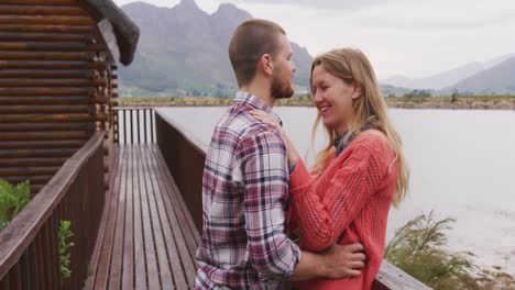 caucasian couple spending time at home together, embracing, looking at each other