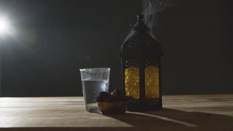 stationary shot of smoke pouring out of lantern during ramadan celebrations