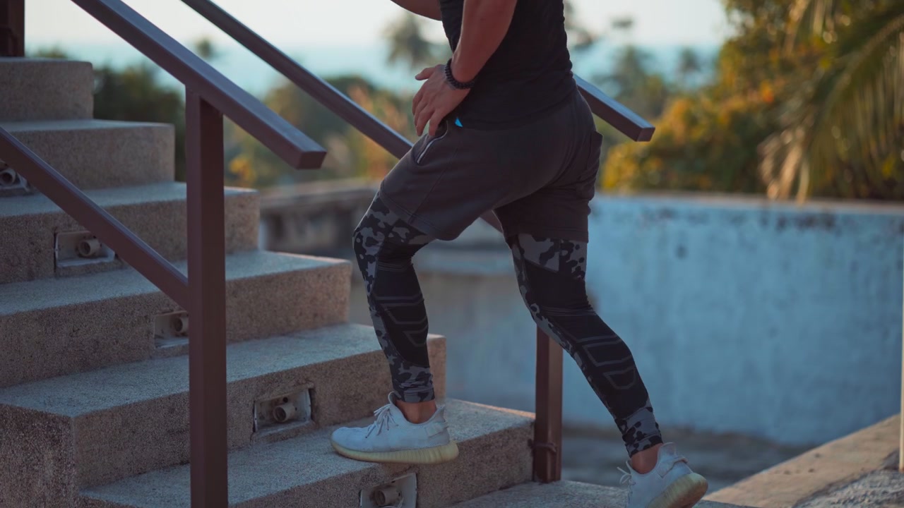 Athletic Man Exercising by Running Up Outdoor Stairs