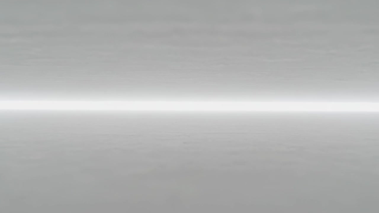 Advancing playback showing subtle tone shifts on studio gray surface with central light band