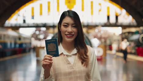 woman with british passport at a train station