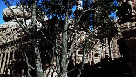 a tree in front of a stone building