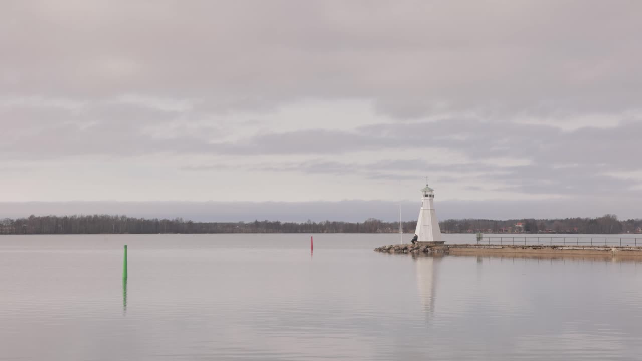 Picturesque View Of Vadstena Lighthouse's Reflection On Vattern Lake In Vadstena, Sweden