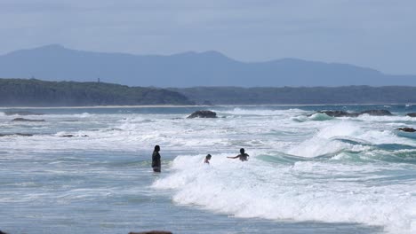 group of surfers enjoying the ocean waves