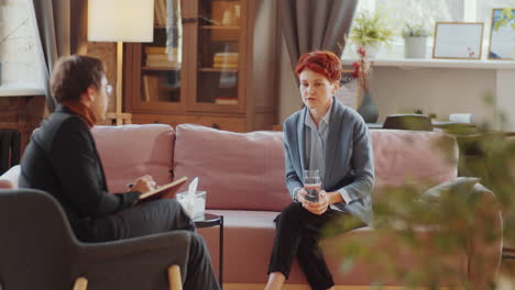 woman speaking with psychologist on therapy session