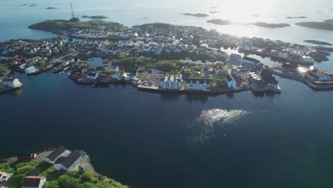 fantastic aerial view in a circle over the city of henningsvaer, with beautiful sunset colors