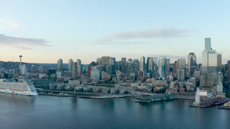 Wide-sweeping-drone-shot-of-Seattle's-downtown-corridor-from-the-perspective-of-the-Puget-Sound