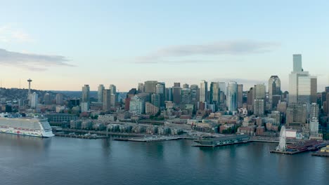 wide sweeping drone shot of seattle's downtown corridor from the perspective of the puget sound