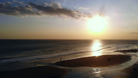 Ascending-while-looking-at-the-incredible-sunset-at-a-sand-beach-filled-with-people