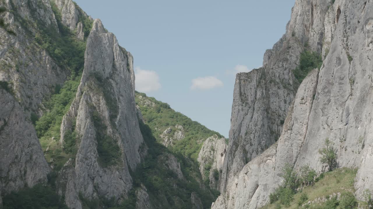 A static wide shot of the majestic Cheile Turzii in Transylvania, Romania. An epic natural landscape with massive limestone cliffs, perfect for travel content