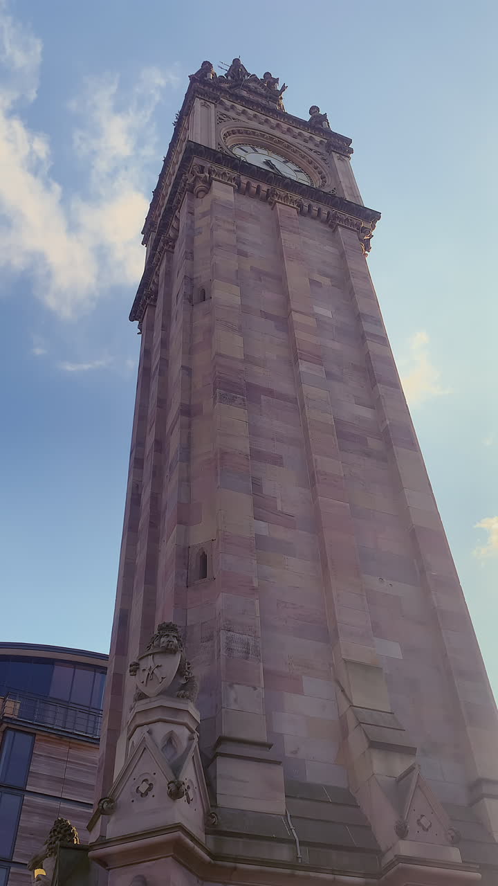 Imposing low angle shot of Albert Memorial Clock in Belfast under blue sky