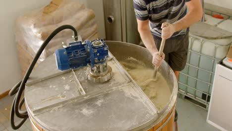 male worker preparing gin in distillery 4k