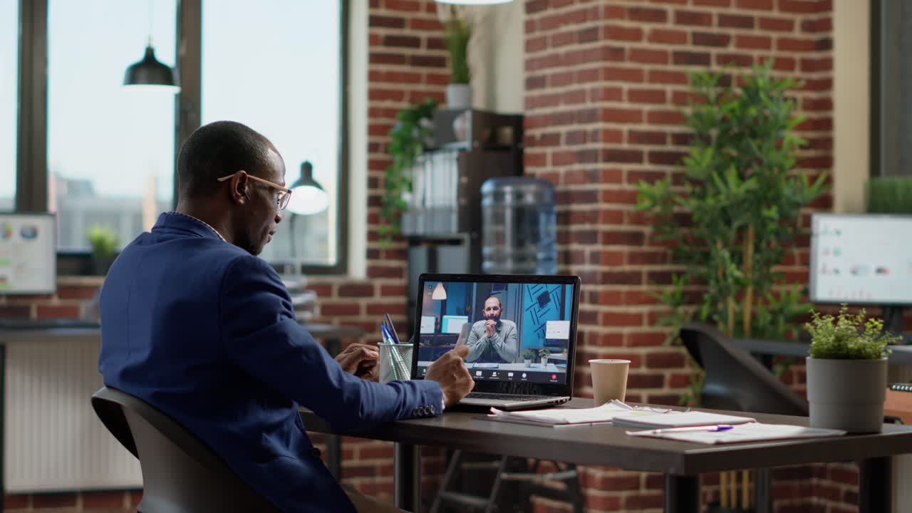 Businessman talking to manager on online teleconference call