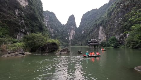 tourists rowing boats in a serene mountain landscape