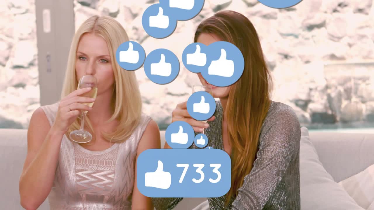 Two women toasting flutes on sofa, sparking social like bubbles rising badge updating celebrating
