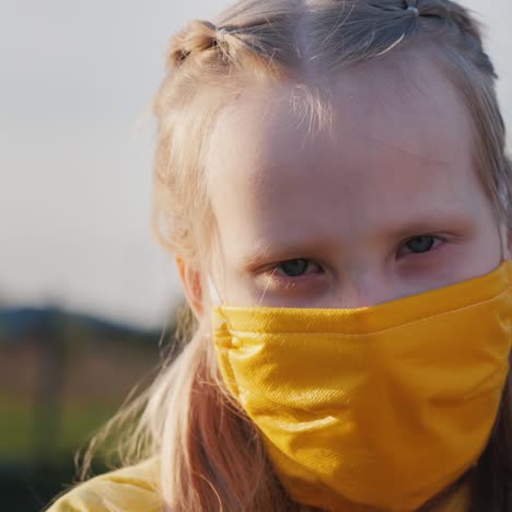 portrait of a girl in a yellow protective mask