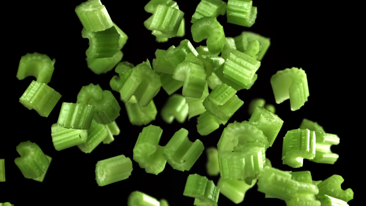 Fresh Chopped Celery Pieces Falling in Slow Motion