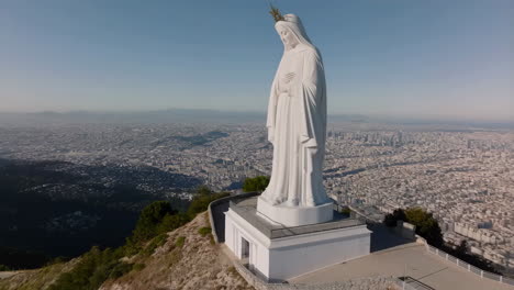 large statue of the virgin mary overlooking a city
