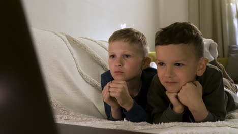 excited kids enjoying film on the sofa