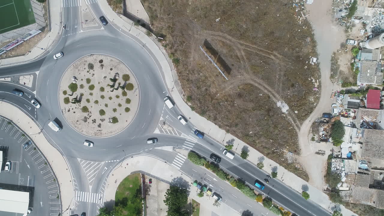 Drone rises from car near roundabout in developing area
