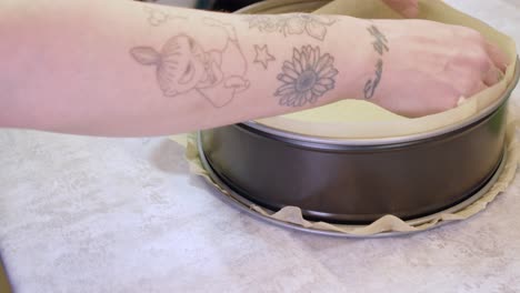 strips of parchment paper line sides of cheesecake springform pan