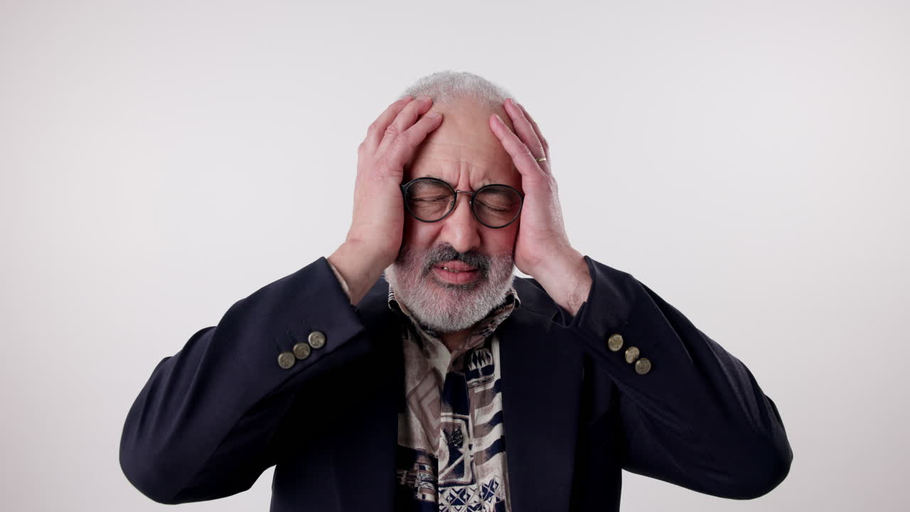 Stressed senior man with headache