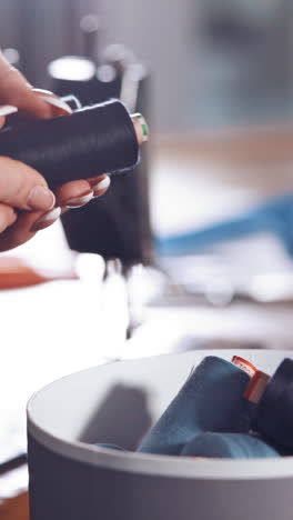box with color sewing threads. close up of woman hands opening tailor box with threads vertical video