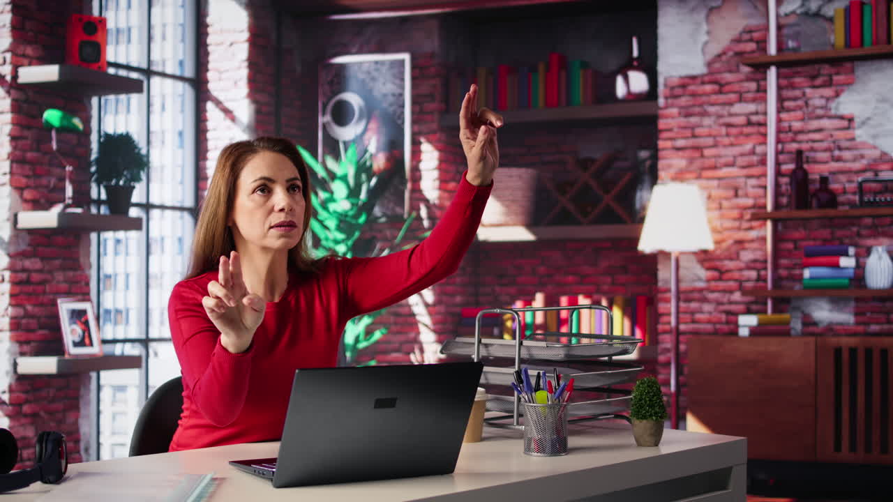 Woman working on a laptop at her desk