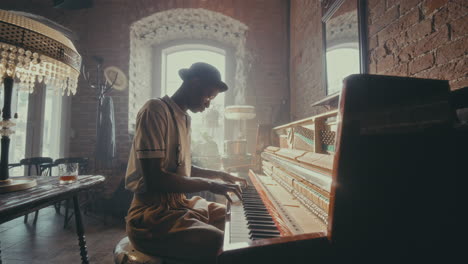 man playing piano in vintage cafe