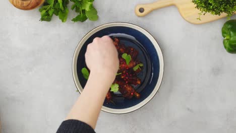 crop person adding spices to barbecue ribs