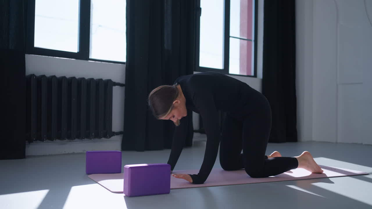 Woman practicing yoga in a studio