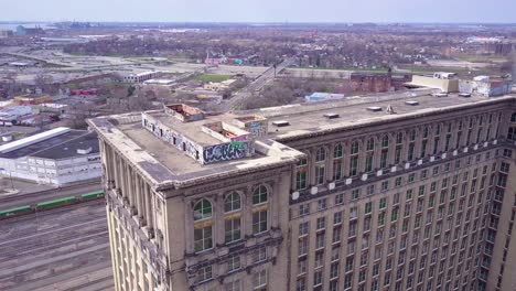 sweeping aerial of the exterior of the abandoned central train station in detroit michigan