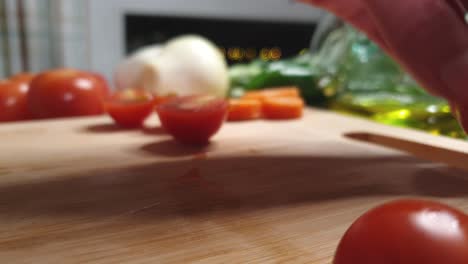 detail of knife cutting small tomatoes