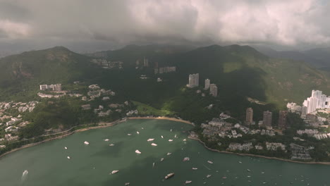 Slow-panning-aerial-drone-shot-of-Deep-Water-Bay,-Hong-Kong,-during-cloudy-day