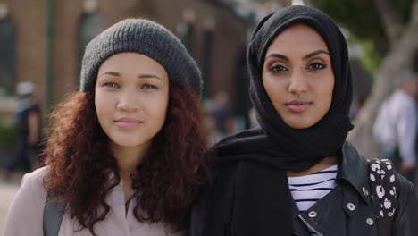 portrait of two young woman friends close up of multi ethnic girlfriends looking at camera serious