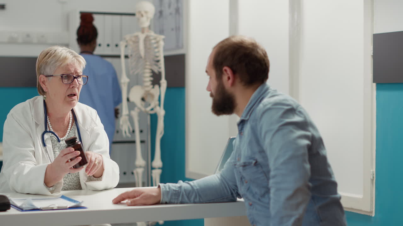 Female physician explaining prescription medicine in bottle