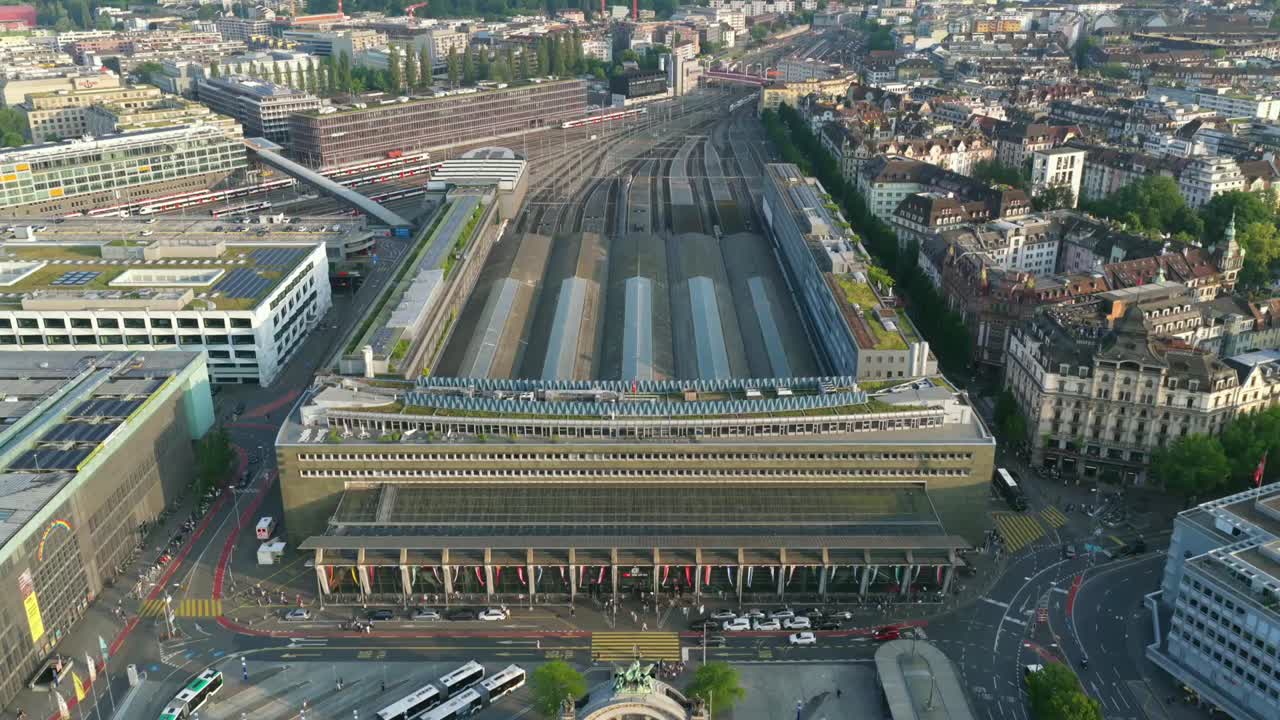 Aerial top-down view of Lucerne’s main bus terminal and train station at golden hour