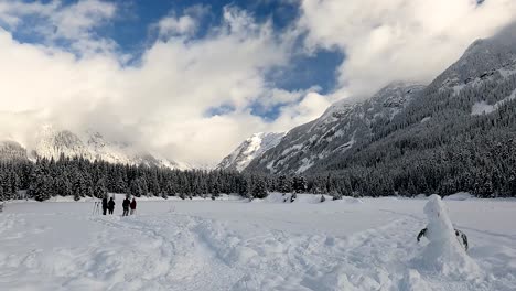 tourist snowshoers at gold creek pond trail at snoqualmie pass in washington state, usa