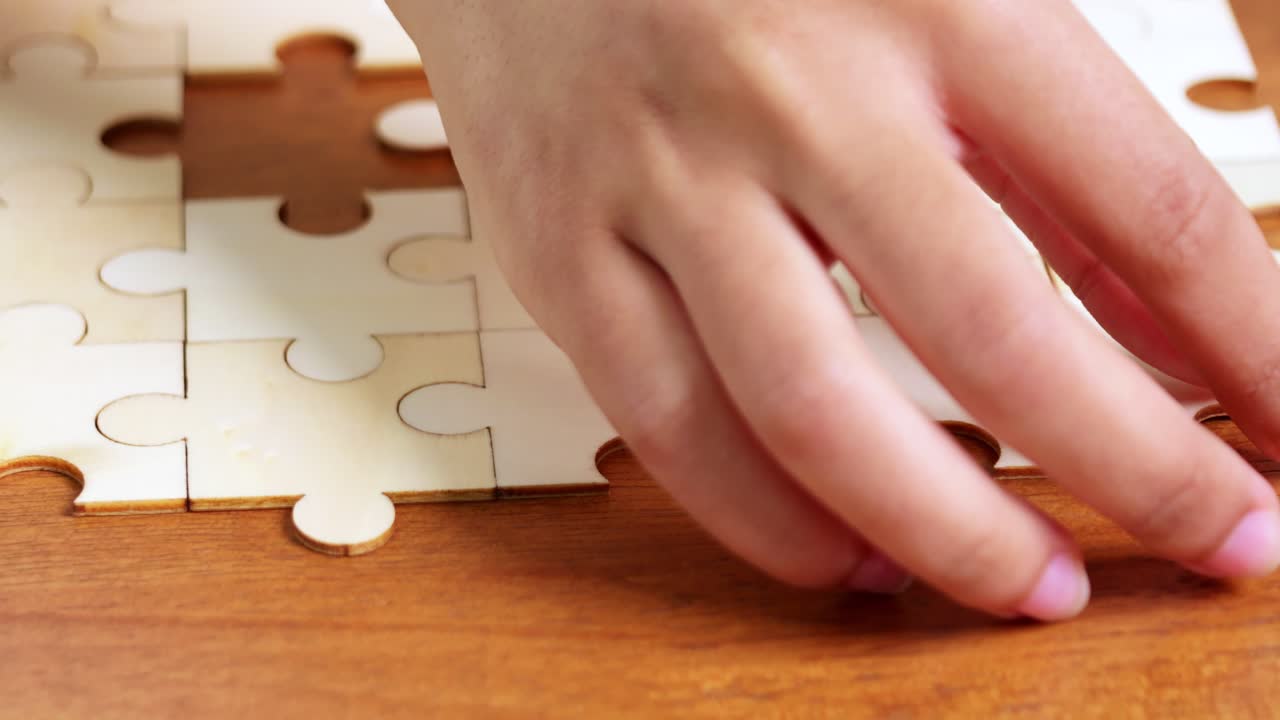 A close-up moment of puzzle assembly illustrates the joy of concentration and creativity in a cozy home setting