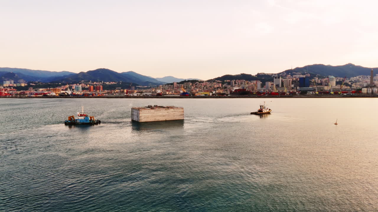 Tugs industrial boats working in the Italian port of Genoa. Aerial