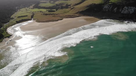 seaside of new zealand south island aerial, the beach, cliffs and green saddle panorama, warm summer day