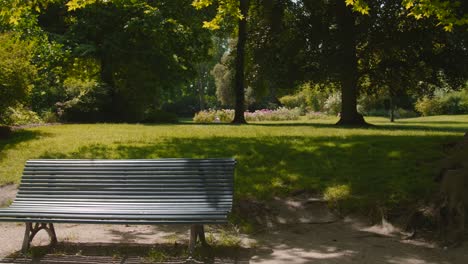 außenbank im französischen stil in einem park während der frühlingssaison – weitwinkelaufnahme