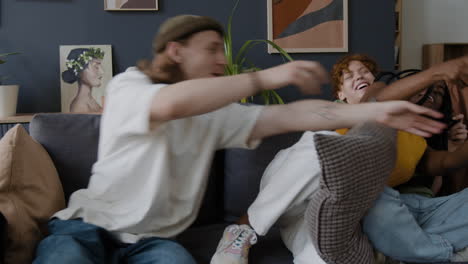 friends having fun playing video games on the couch