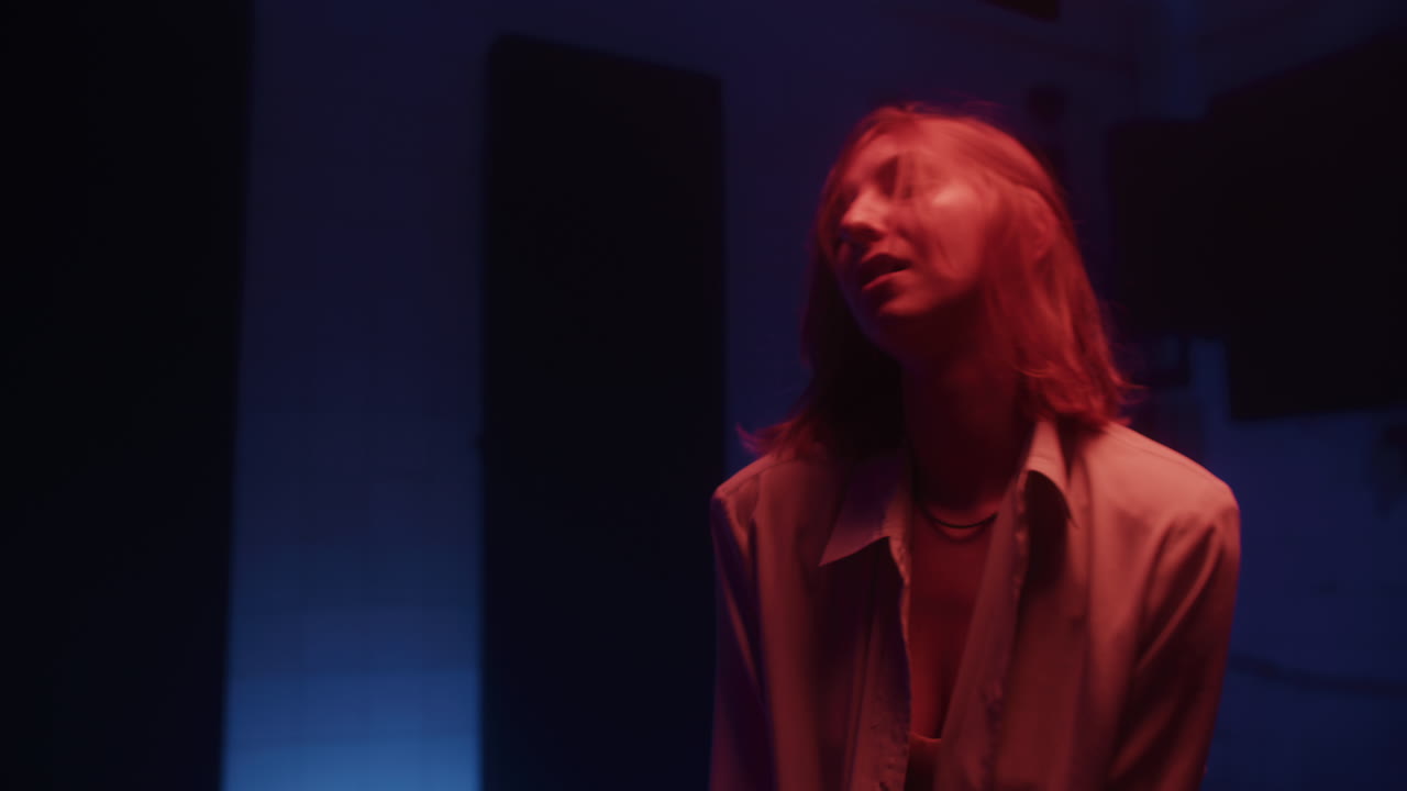 Woman in Studio Under Colorful Lighting